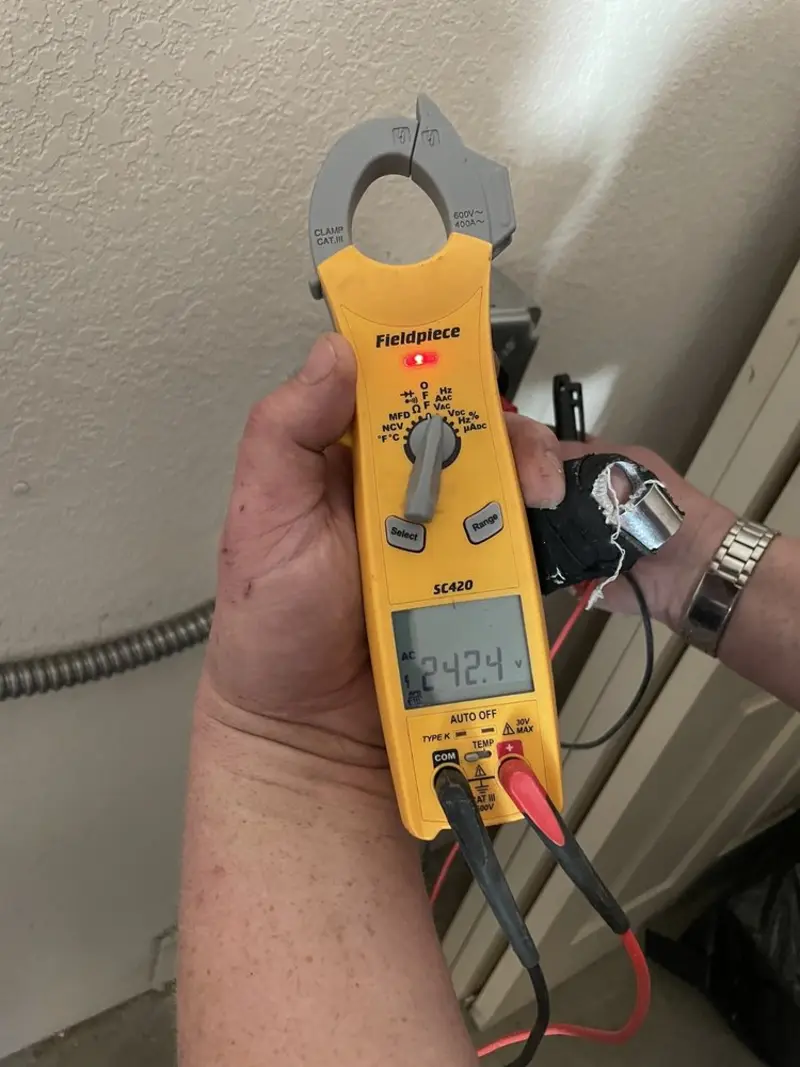 Voltage testing with clamp meter during Whole House Surge Protector in Owens Cross Roads